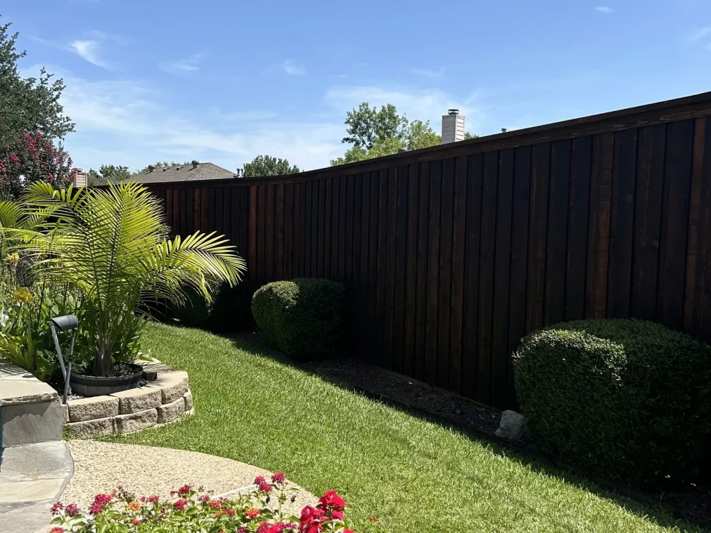 250 linear feet of stained western red cedar fence running the length of a landscaped property in Mansfield, TX