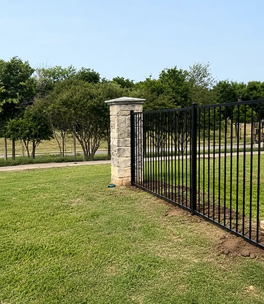 6 ft iron fence tied into an existing stone column in Cedar Hill, TX
