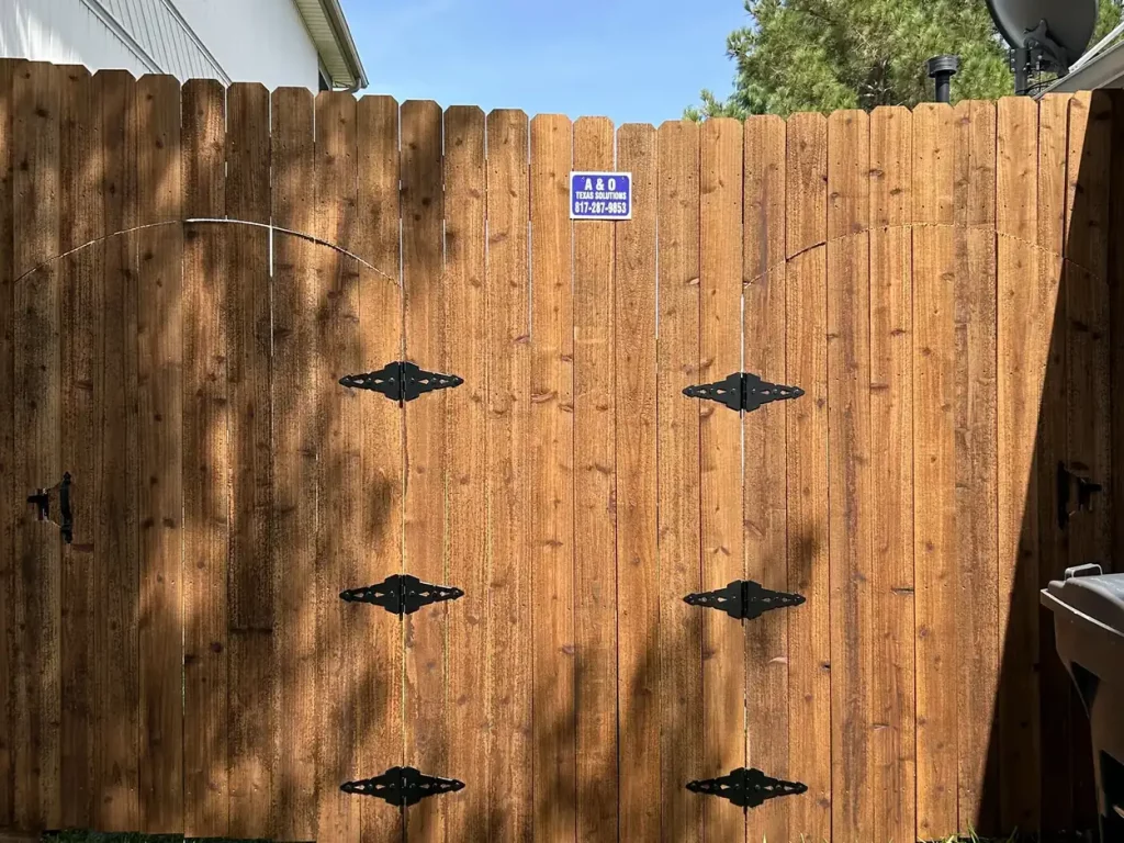 8 ft privacy fence in Arlington, TX with a stained cedar double gate on black strap hinges