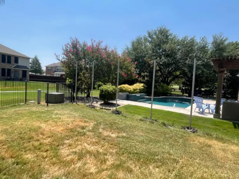 Post line for a new 8 ft privacy fence across a backyard in Frisco, TX