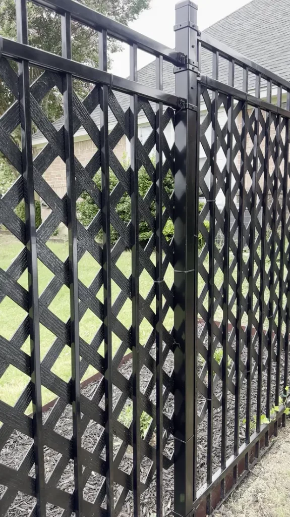 Black lattice privacy panel beside an iron fence in Cedar Hill, TX
