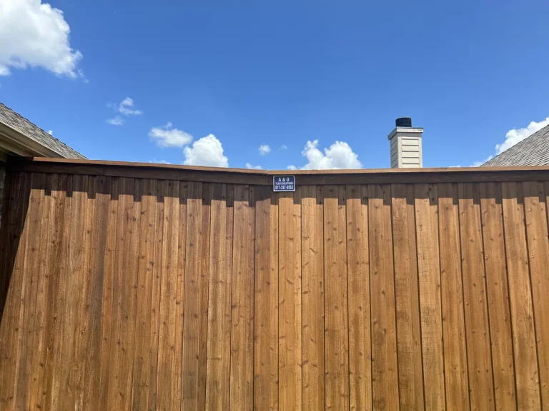 Cedar cap and trim along the top of a fence in Grand Prairie, TX