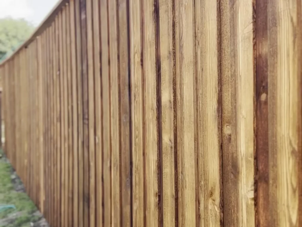 Finished 8 ft cedar fence in Fort Worth, TX with board-on-board pickets and a capped top lin