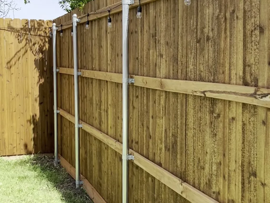 Galvanized metal posts, rails and baseboard on a cedar fence in Arlington, TX