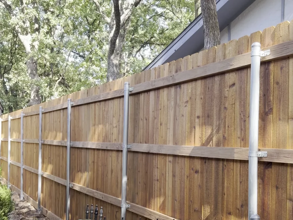 Steel posts and three treated rails on an 80 ft cedar fence installation in Arlington, TX