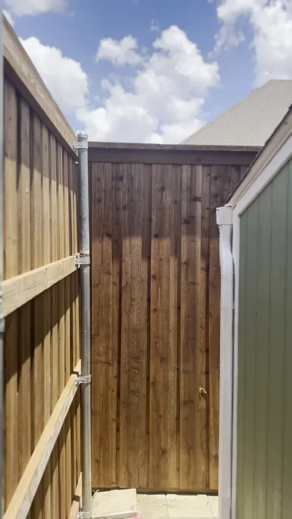 Rebuilt cedar fence running along a side yard in Grand Prairie, TX