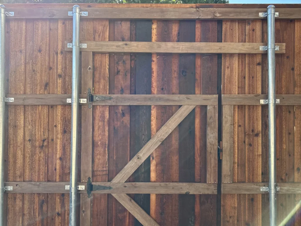 New cedar gate with a braced wood frame on a privacy fence in Plano, TX