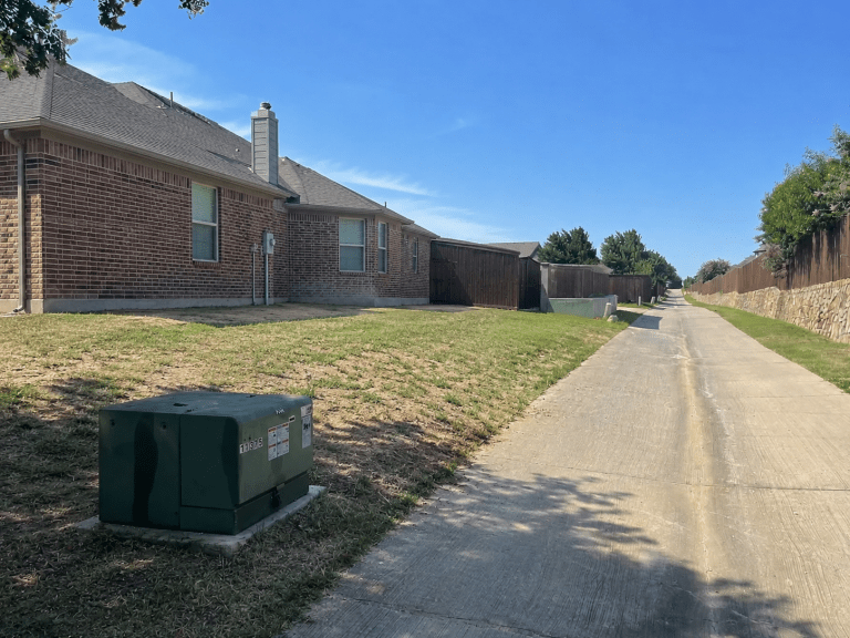 Before photo of a cedar privacy fence replacement project in Frisco, Texas