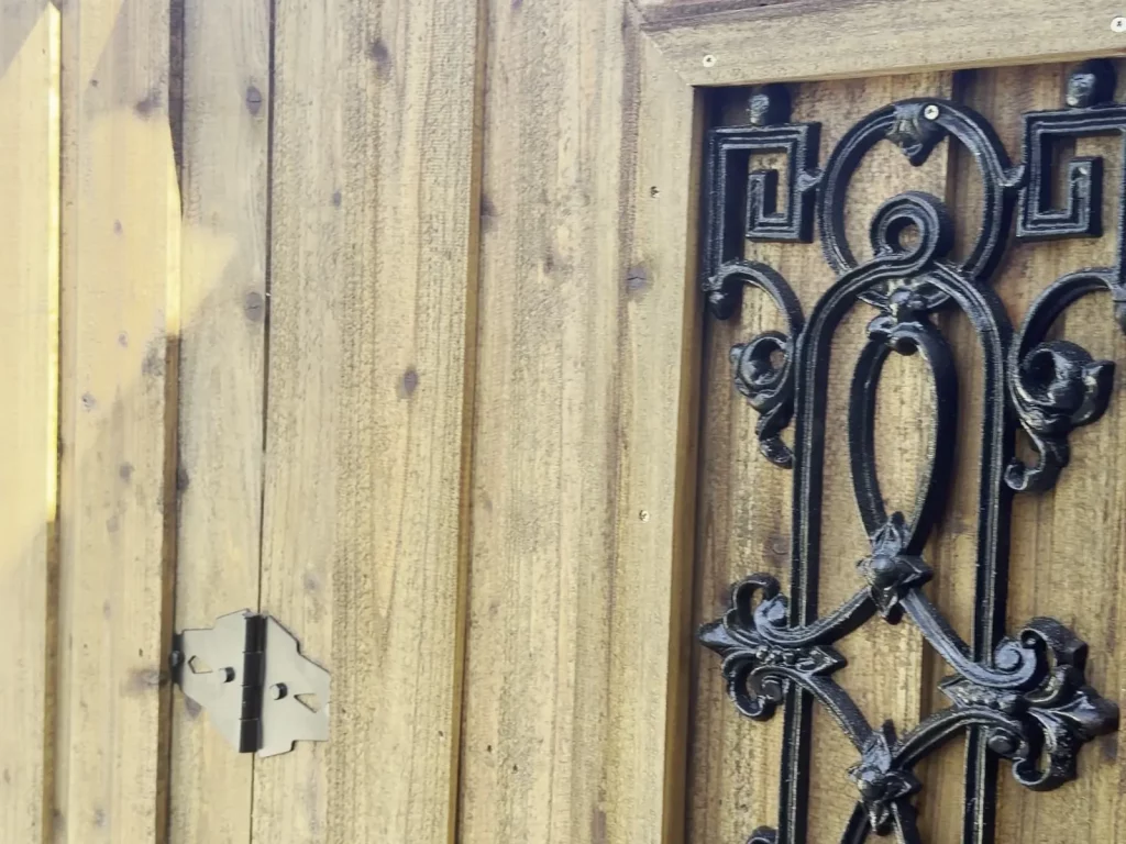 Decorative iron insert set into a cedar gate on a privacy fence in Cedar Hill, TX