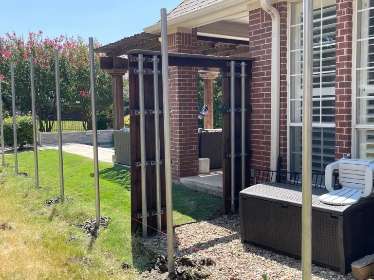 Fence posts set beside a patio and pergola in Frisco, TX