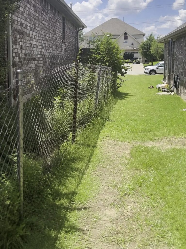New rails being fastened to existing fence posts in Grand Prairie, TX