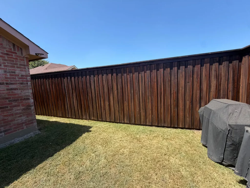 145 linear feet of wood fence after restaining in DeSoto, TX