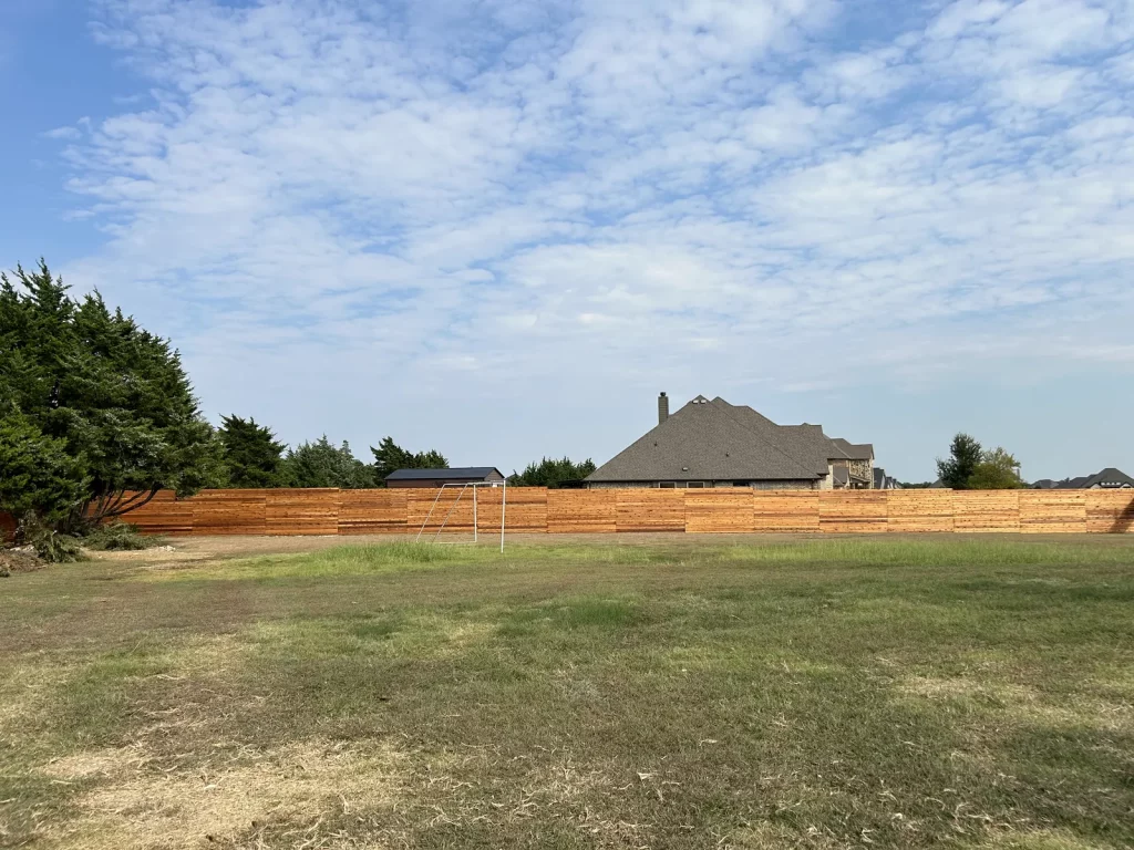 Horizontal cedar fence enclosing an acreage property perimeter in [City], TX