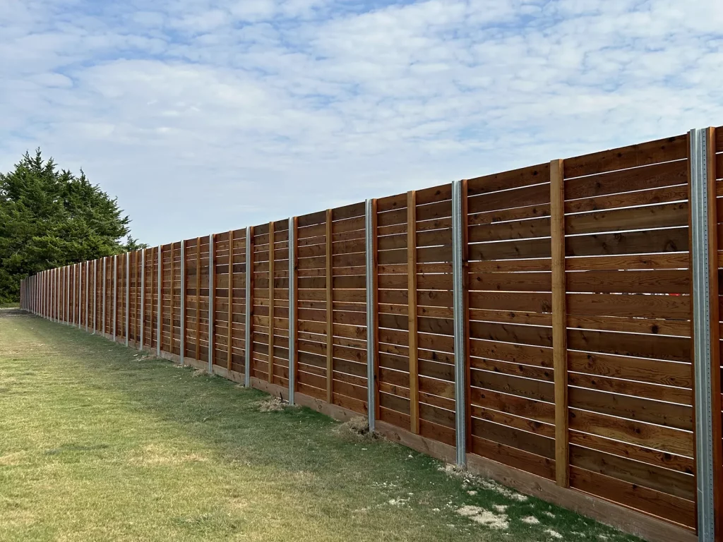Horizontal cedar fence in [City], TX built on exposed galvanized steel posts along an open property line
