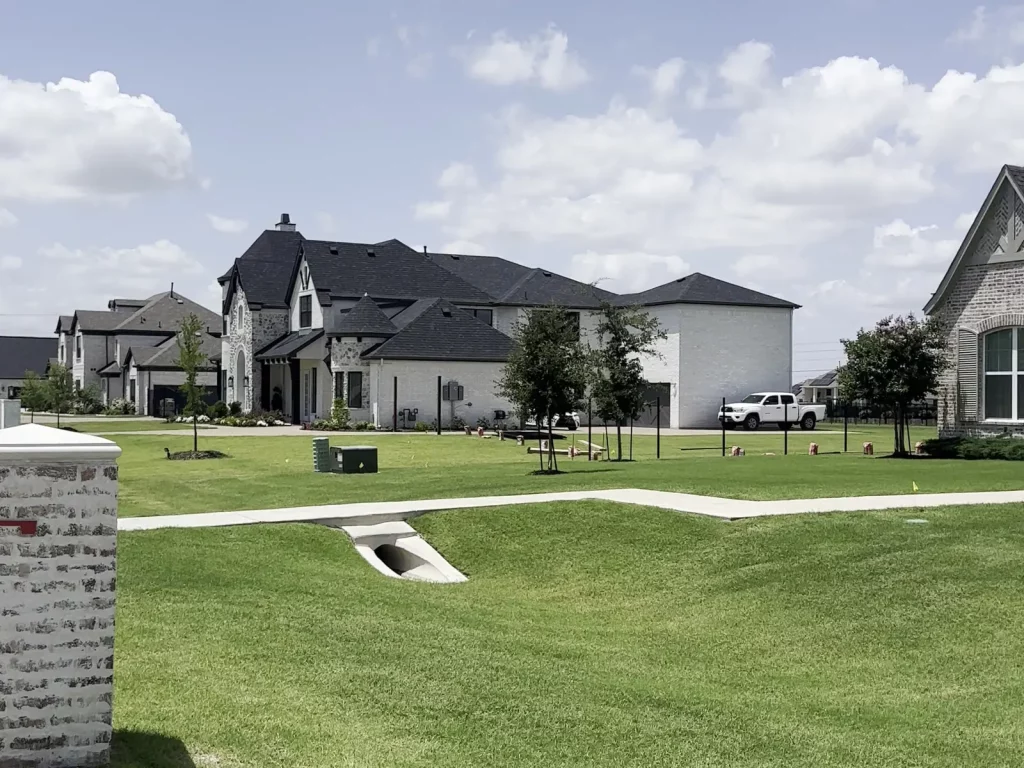 Street frontage of a new-build property in Allen, TX where the wrought iron fence line was installed