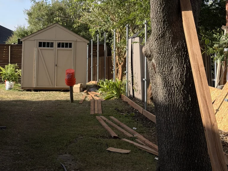 Steel posts and treated baseboard set for a side by side cedar fence in Arlington, TX