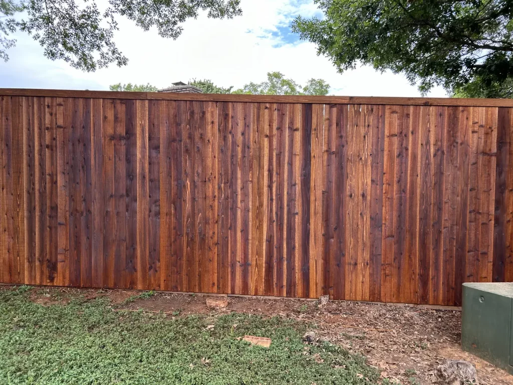 Stained 1x6 cedar pickets and top trim on a new privacy fence in Arlington, TX