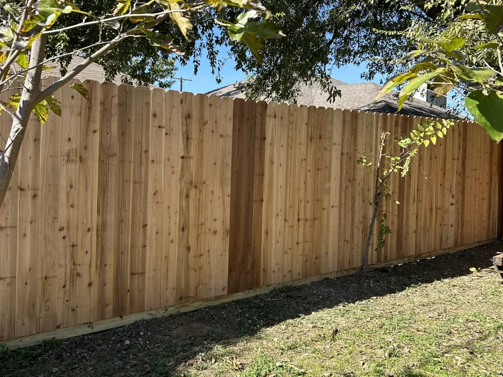 New unstained cedar fence enclosing a backyard boundary in Arlington, TX