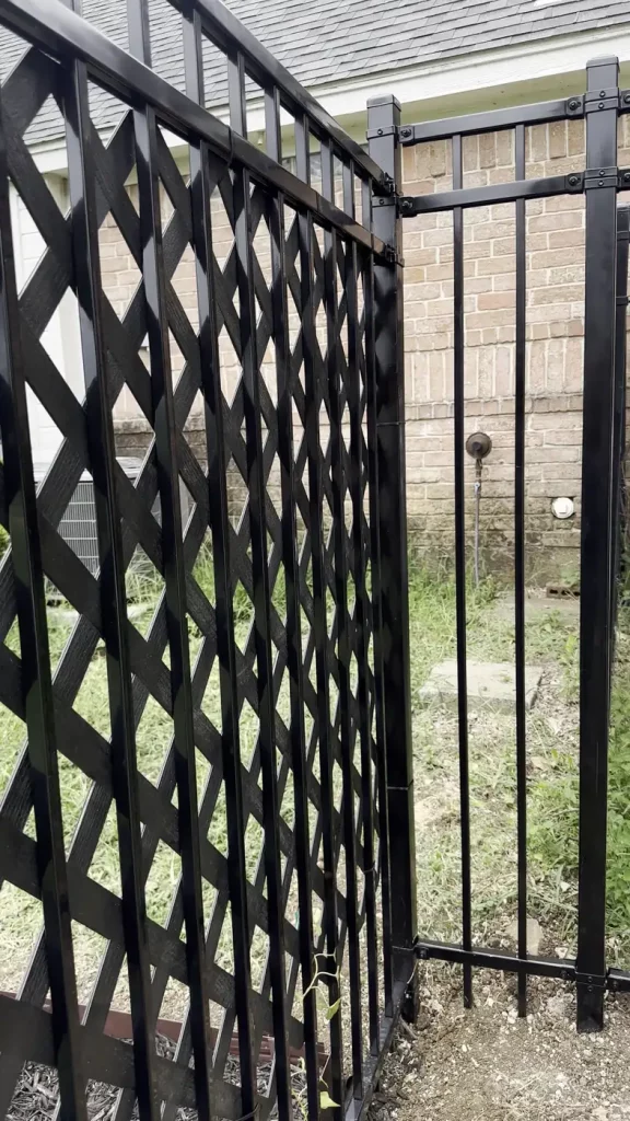 Wrought iron gate beside a black lattice privacy panel in Cedar Hill, TX