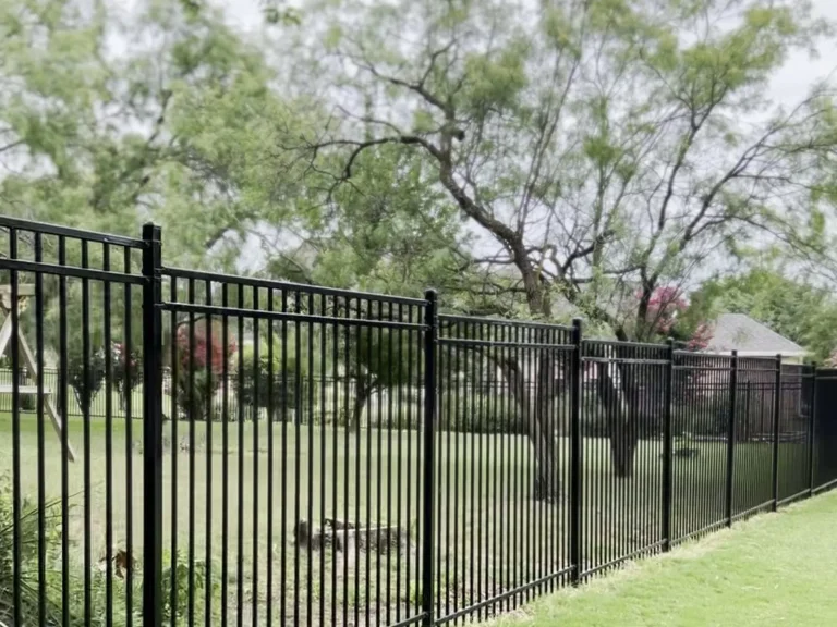 Black wrought iron fence installation surrounding a backyard pool in Barry,