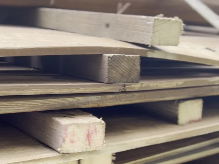 Cedar lumber staged for an AC unit screening fence project in Southlake, TX