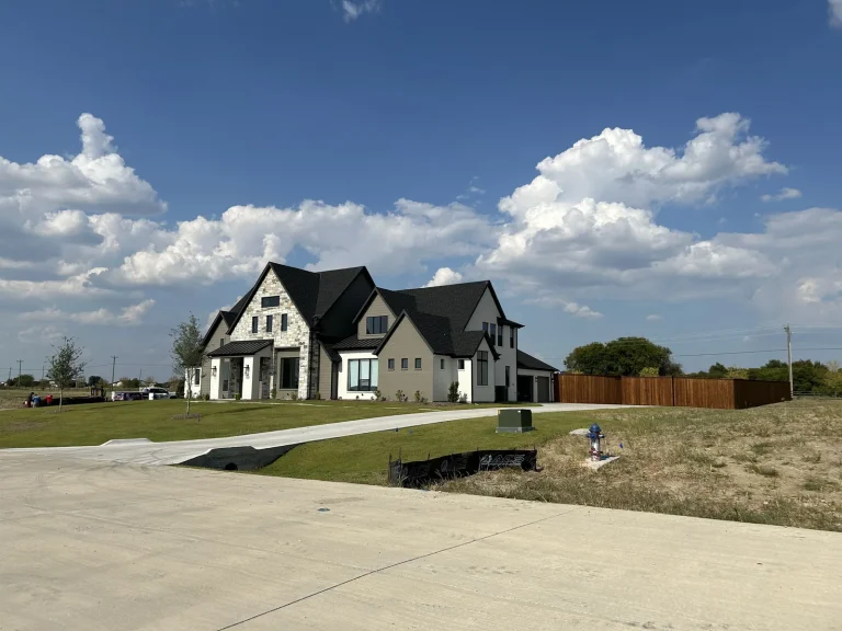 Finished cedar fence picket replacement project beside a custom home driveway in Watauga, TX