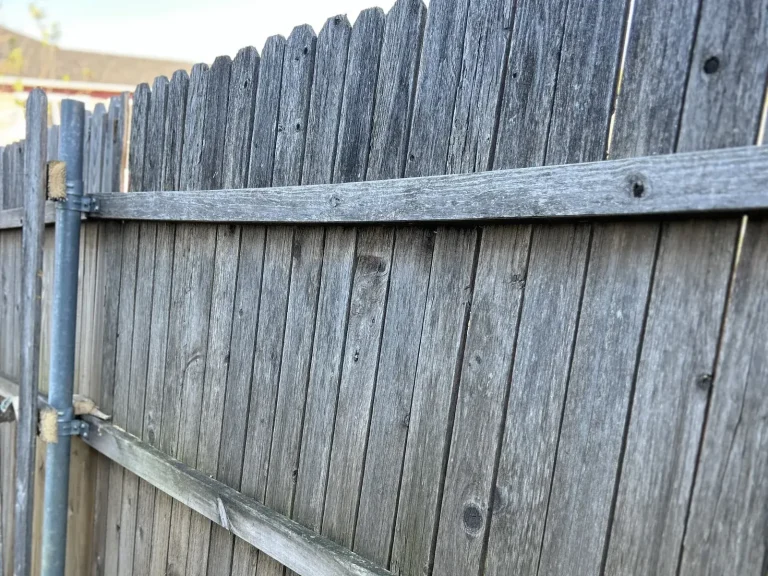 Natural unstained cedar fence installation along a property line in Glenn Heights, TX