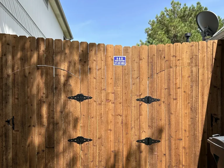 Cedar gate with decorative wrought iron strap hinges installed in Westworth Village, TX