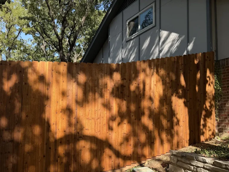Side-by-side cedar fence installation shown beside the home in Arlington, TX
