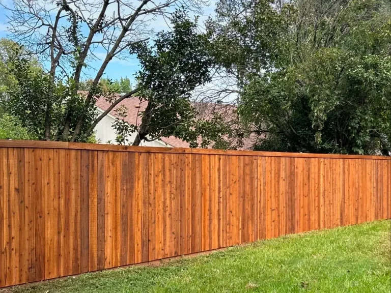 Long finished cedar privacy fence enclosing a spacious backyard in Haslet, TX