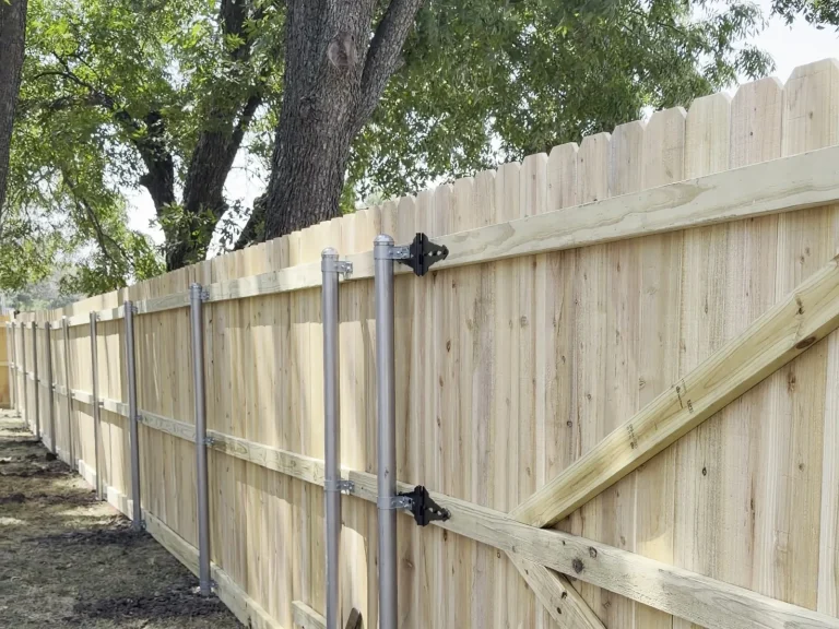 Cedar fence framing with cap and trim boards under construction in Midlothian, TX