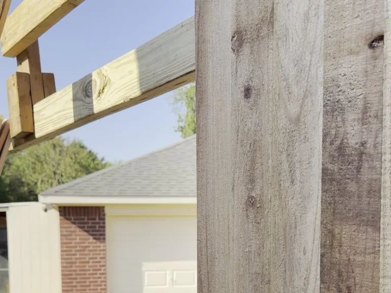 Pressure-treated rails framing a cedar fence in Irving, TX before pickets