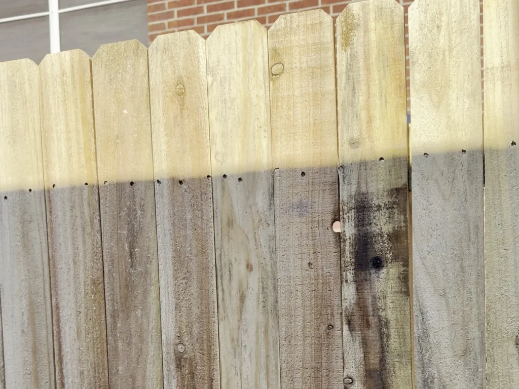 Cedar fence in Irving, TX 75060 running alongside a brick house