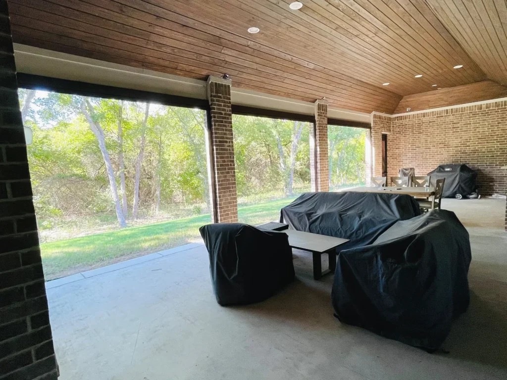Motorized screen installation in Celina, TX seen from the opposite end of the patio, screens open