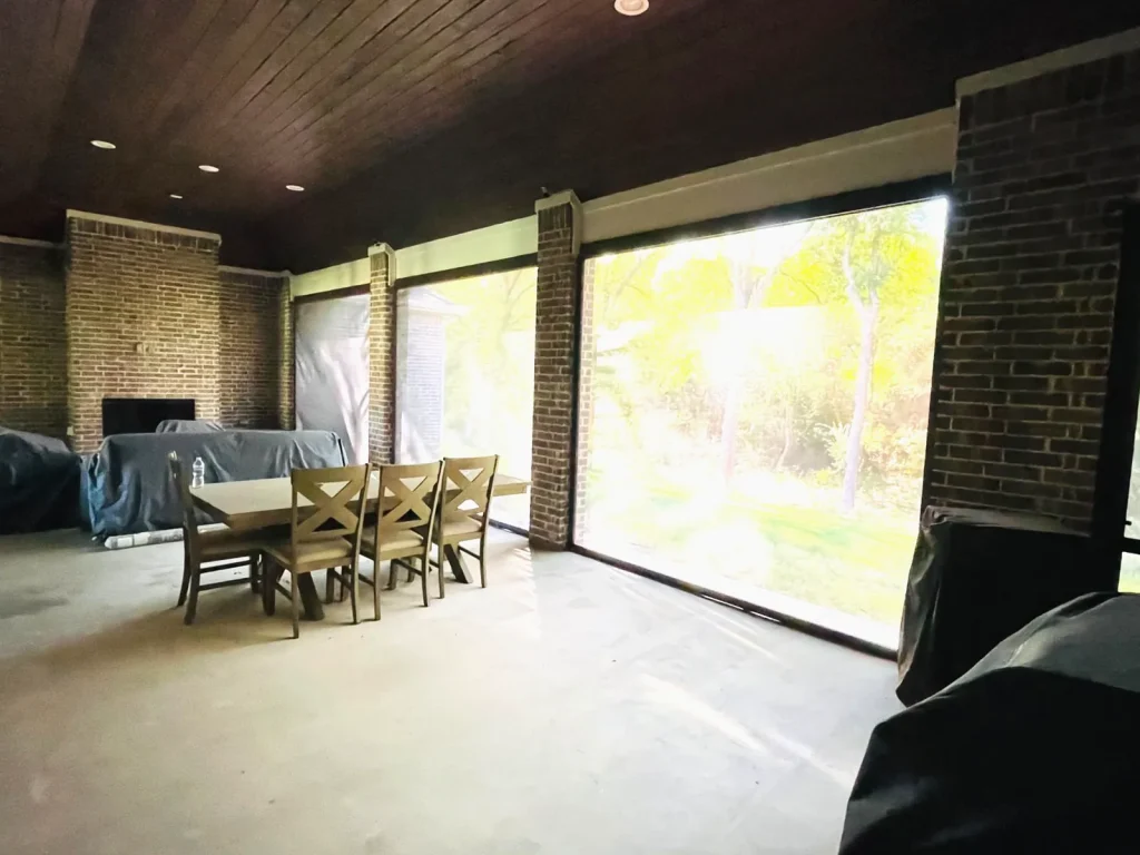 Retractable patio screens in Celina, TX lowered, with the yard still visible through the fabric