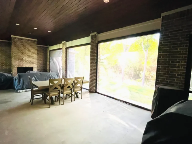 Retractable patio screens in Celina, TX lowered, with the yard still visible through the fabric